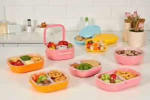 Colorful bento boxes for kids arranged with healthy school lunch portions and snacks